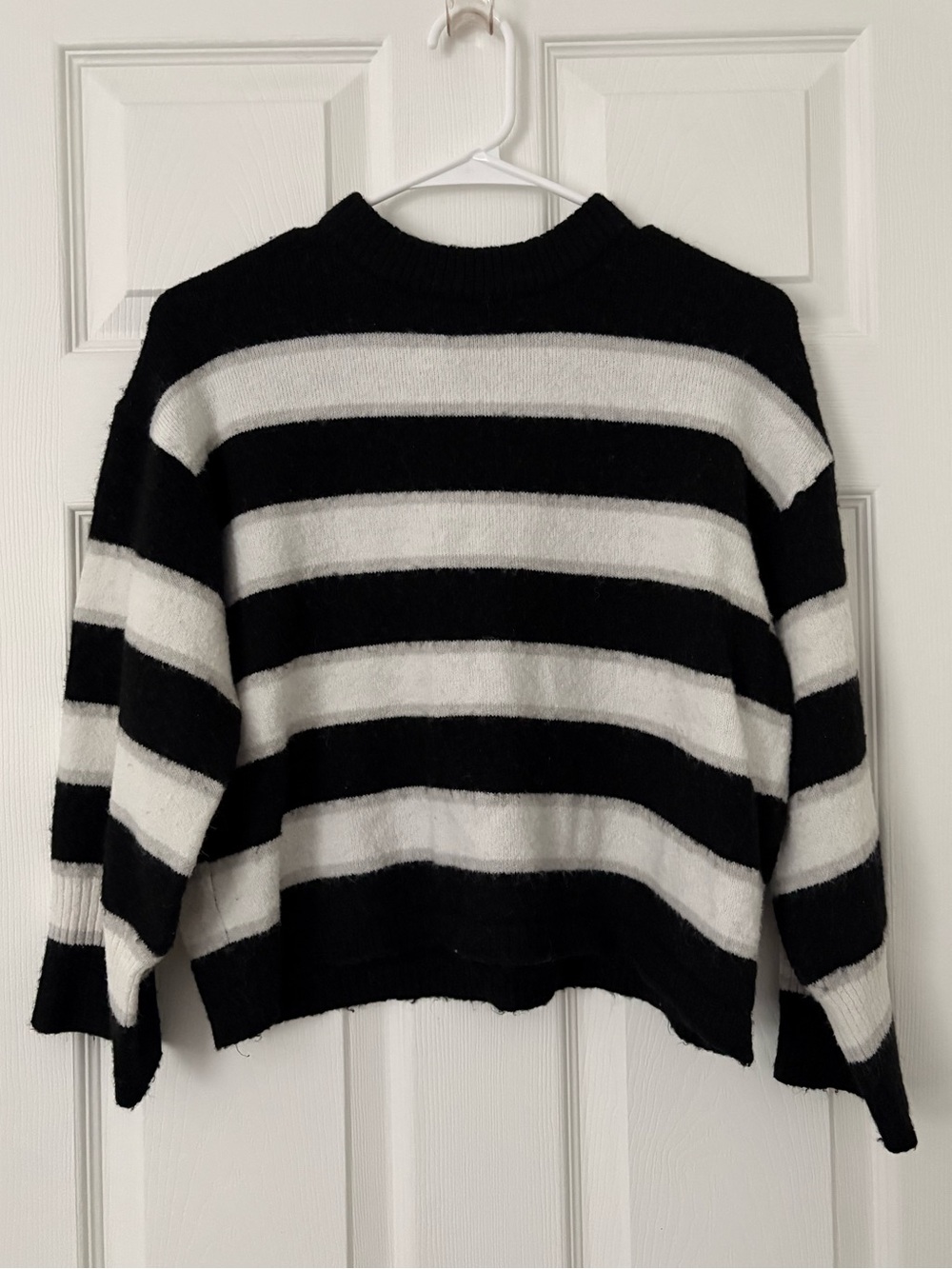 black, white, and gray sweaters